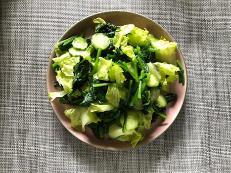 plate of spinach topped with citrus slices